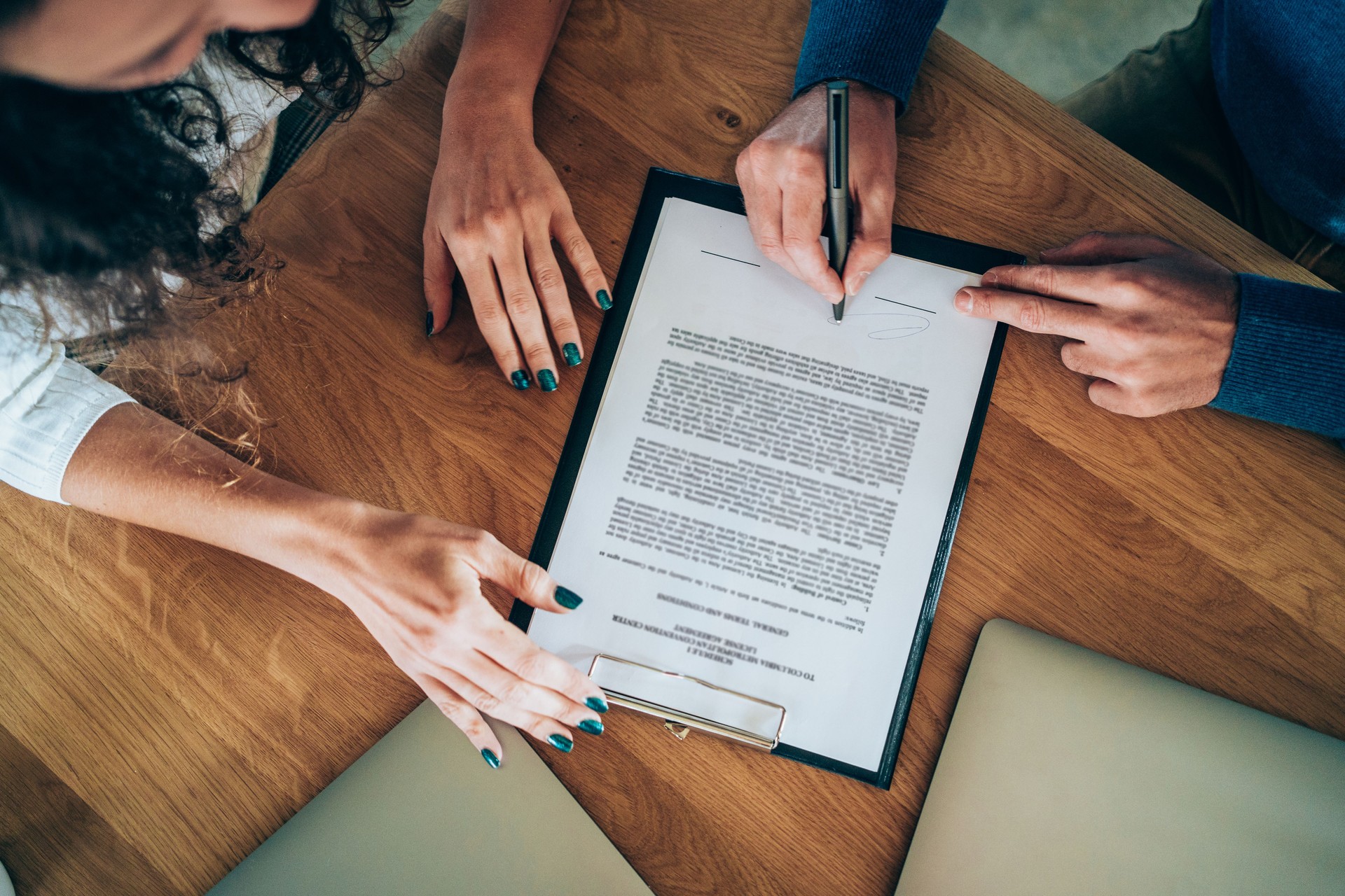 Business people signing a contract.